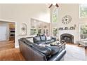 Open living area with fireplace, hardwood floors, and a large window letting in natural light at 417 Rhodes House Dr, Suwanee, GA 30024