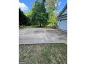 Large driveway with space for parking and views of the surrounding yard and trees at 5028 Highway 81, Mcdonough, GA 30252