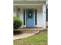 Inviting front entrance with a light blue front door, sidelights, and decorative trim at 5028 Highway 81, Mcdonough, GA 30252
