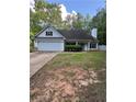 Charming one-story home featuring an attached garage and a well-maintained front yard with mature trees and shrubs at 5028 Highway 81, Mcdonough, GA 30252