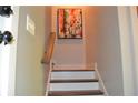 Stairway featuring neutral walls, white risers, wood treads, and a handrail at 1350 May Avenue # 14, Atlanta, GA 30316