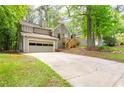 Two-story home with attached garage and freshly landscaped front yard, creating a welcoming first impression at 2445 Deerfield Nw Dr, Kennesaw, GA 30144