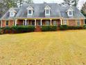 Attractive brick home featuring dormer windows, shutters, and a well-manicured front lawn at 325 Northmill Pkwy, Stockbridge, GA 30281