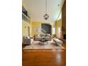 Bright living room with hardwood floors, fireplace, high ceilings, and neutral furniture at 325 Northmill Pkwy, Stockbridge, GA 30281
