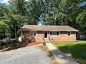 Charming brick home with a well-manicured lawn and inviting walkway at 2059 Clearwater Se Dr, Marietta, GA 30067