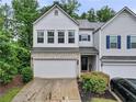 Charming two-story townhome featuring a two-car garage and well-maintained landscaping at 218 Piedmont Cir, Canton, GA 30114