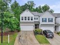 Charming two-story townhome featuring a two-car garage, ample parking, and lush landscaping at 218 Piedmont Cir, Canton, GA 30114