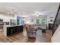 Bright open floor plan with a modern kitchen island, fireplace, and cozy living area at 218 Piedmont Cir, Canton, GA 30114