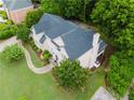 Overhead angle of a home highlighting the roof, backyard, and mature trees surrounding the property at 2552 Berwick Walk, Snellville, GA 30078