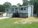 Gray two-story house with a two-car garage, dark trim and a beautifully landscaped yard at 2845 Woodhollow Ln, Jonesboro, GA 30236