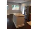 Kitchen island with granite countertops and a stainless steel refrigerator at 4324 Rocklane Dr, Conley, GA 30288