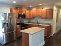 Modern kitchen with stainless steel appliances, granite countertops, and an island, perfect for culinary enthusiasts at 4324 Rocklane Dr, Conley, GA 30288