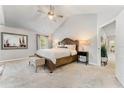 Serene main bedroom featuring a vaulted ceiling, plush carpet, and elegant furnishings at 592 Hayes Rd, Auburn, GA 30011
