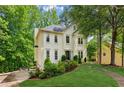 Well-maintained two-story home featuring mature trees, inviting landscape, and a spacious driveway at 1667 Willow Way, Woodstock, GA 30188