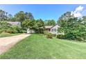 Inviting property with a spacious lawn, mature trees, and a convenient two-car garage at 4546 Windsor Oaks Ct, Marietta, GA 30066