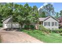 Attractive home showcasing a well-kept lawn, lovely landscaping, and an attached two-car garage at 4546 Windsor Oaks Ct, Marietta, GA 30066