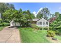 Beautiful home with well-maintained landscaping, lush greenery, and a double garage at 4546 Windsor Oaks Ct, Marietta, GA 30066