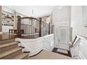 Bright foyer featuring elegant staircase with carpeted steps, wood railing, and views to the living room at 4538 Collins Ave, Sandy Springs, GA 30342