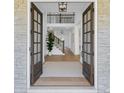 Elegant entryway showcasing a grand foyer, staircase, and natural light streaming in from open doors at 6355 Westfallen Overlook, Cumming, GA 30040