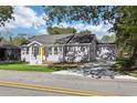 Charming single-story home with yellow front door and well-manicured lawn at 7540 Conyers St, Lithonia, GA 30058