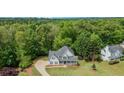 Aerial view of a home nestled in a wooded neighborhood, showcasing its expansive yard at 102 Woodsfield Ln, Hiram, GA 30141