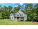 Beautiful two-story home with a large front yard and classic architectural details at 102 Woodsfield Ln, Hiram, GA 30141
