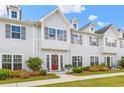 Inviting townhome exterior with gray siding, dormer windows, and professionally landscaped front yard at 1700 Prospect Way, Conyers, GA 30094