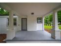 Spacious covered porch with painted brick pillars, gray painted floor, and a view of the front yard at 2137 Delowe Dr, Atlanta, GA 30344