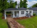Beautifully landscaped yard of this charming single-story home featuring a covered porch at 2137 Delowe Dr, Atlanta, GA 30344