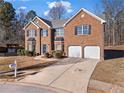 Charming two-story brick home with attached two-car garage, mailbox, and well-maintained landscaping at 221 Cutbank Sw Ct, Atlanta, GA 30331