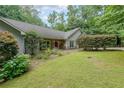 Well-manicured front lawn, complemented by mature trees and established shrubs, creating a welcoming facade at 3601 Club Nw Dr, Kennesaw, GA 30144