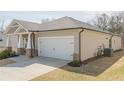 Showing the right side of the home with a two-car garage, nice landscaping, and neutral colored siding at 422 Murphy Avenue, Canton, GA 30114