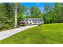 Beautiful home exterior surrounded by lush greenery and a well-maintained lawn at 1155 Peachtree Battle Nw Ave, Atlanta, GA 30327