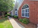Beautiful home exterior with brick accents, arched windows, and lush greenery at 174 Vintage Club Cir, Marietta, GA 30066