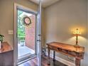 Warm foyer featuring hardwood floors, console table, and a view of the front yard at 174 Vintage Club Cir, Marietta, GA 30066