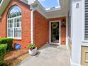 Inviting front entrance with brick facade, wreath, and neatly trimmed landscaping at 174 Vintage Club Cir, Marietta, GA 30066