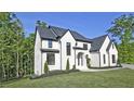 Elegant two-story home with dark accents and lush green lawn at 2346 East Maddox Rd, Buford, GA 30518