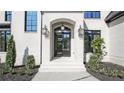 Close-up of the front entrance with elegant black framed windows and modern lighting at 2346 East Maddox Rd, Buford, GA 30518