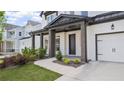 Welcoming covered front porch with dark wood pillars, a stylish front door, and professional landscaping at 298 Tillman Pass, Woodstock, GA 30188