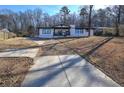 Charming single-story home with long driveway and mature trees in the front yard at 52 Buena Vista Se Cir, Cartersville, GA 30121
