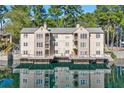 Condo with exterior balconies overlooking a serene lake creating a picturesque waterfront living experience at 610 Mill Pond Se Dr, Smyrna, GA 30082