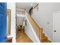 Inviting foyer featuring a staircase and hardwood floors, leading to a living area with a cozy fireplace at 865 Ashfield Dr, Decatur, GA 30030