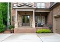 Inviting front porch with stone accents, cozy seating, and stylish lighting fixtures at 2239 Tayside Nw Xing, Kennesaw, GA 30152