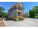 Beautiful two-story home featuring double balconies, lush landscaping and an expansive driveway at 3416 Harrison Rd, Atlanta, GA 30344