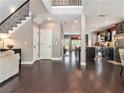 Bright entryway featuring hardwood floors, staircase, and open access to the kitchen and living areas at 1580 Johnson Nw Rd, Atlanta, GA 30318