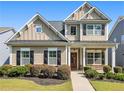 Inviting two-story home with a covered front porch and beautifully manicured front yard at 1580 Johnson Nw Rd, Atlanta, GA 30318