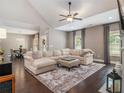 Bright living room boasts a vaulted ceiling, ceiling fan, plush rug, fireplace, and a seamless dining area connection at 1580 Johnson Nw Rd, Atlanta, GA 30318