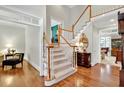 Welcoming foyer with hardwood floors, staircase, and views into the adjacent living spaces at 2250 Edgemere Lake Cir, Marietta, GA 30062