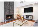 Living room showcasing a stone fireplace, hardwood floors, and stylish furnishings at 2075 Six Branches, Roswell, GA 30076
