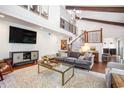 Stylish living room featuring a staircase, hardwood floors, and comfortable seating at 2075 Six Branches, Roswell, GA 30076